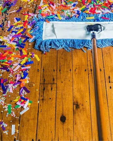 Broom cleaning up confetti