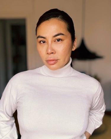 a woman in a white turtle neck sweater