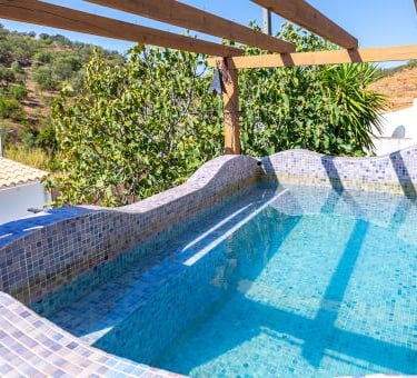a pool with a wooden deck and a pool