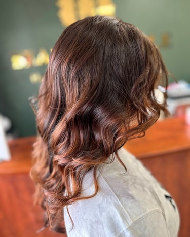 a woman with a short haircut and a white shirt