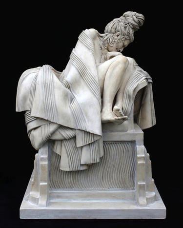 Ceramic sculpture of grieving woman wrapped in blanket on large classical plinth.