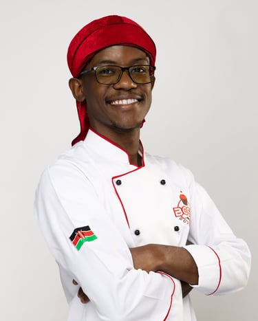 a man in a chef's uniform and a red hat