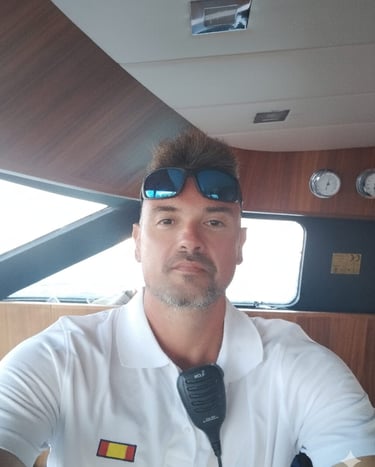 a man in a white shirt and sunglasses, yacht skipper