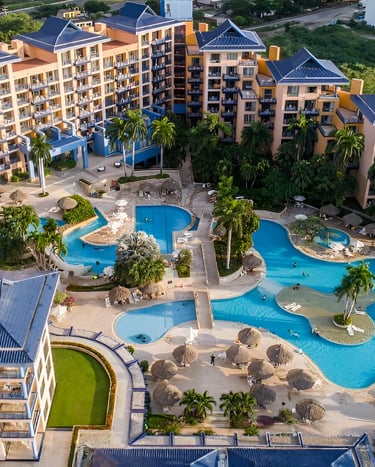a large pool surrounded by hotel rooms at villavicencio
