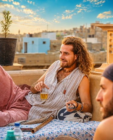 Backpackers enjoying the rooftop café at Open Road Hostel in Jaisalmer.