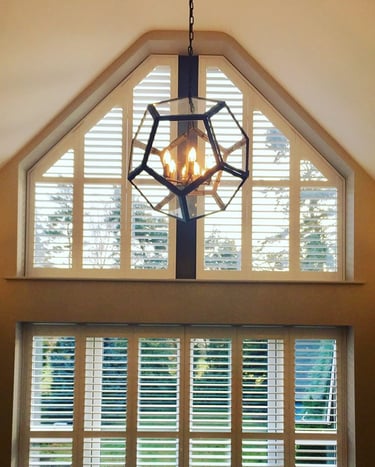 picture of internal hardwood shutters in a shaped window