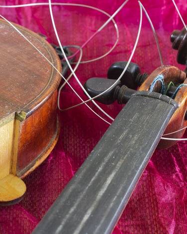 Broken violin where the neck has come off