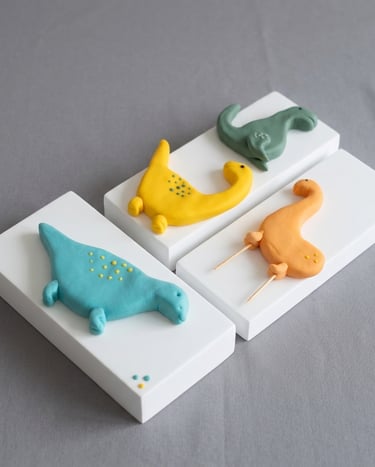 Dinosaurios en fondant modelados a mano por Cocina con Ely, diseñados para la decoración de tortas i
