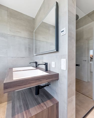 modern natural bathroom with walk-in shower, stone walls and wood vanity
