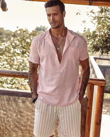 a pink shirt and white shorts