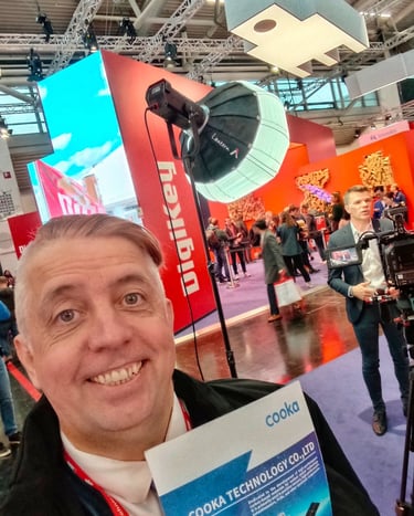 a man holding a book in front of a camera