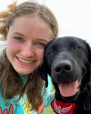 a dog and her student puppy raiser pose for a selfie