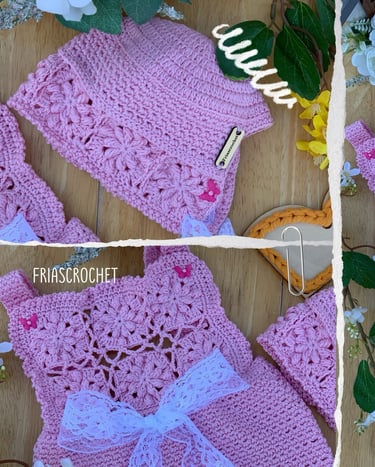 Handmade pink crochet baby outfit featuring a floral pattern dress with lace bow and matching beanie hat.