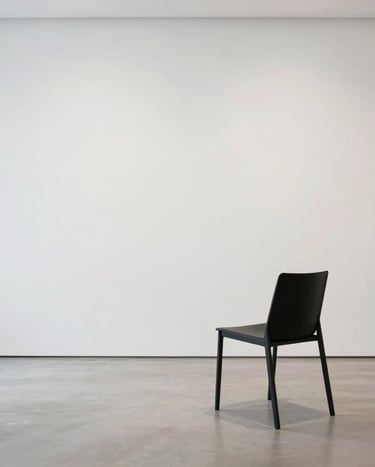 Lifestyle photograph of a person in a minimalist black chair within a bright white gallery space, focus on clean lines and negative space, artistic and calm, International Professional context.