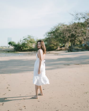 Woman walking on the beach during an intimate couple photography session at Novotel Bali Benoa in Tanjung Benoa Bali.