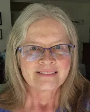Photo of Dawn Standke, a woman with blonde silver hair and glasses