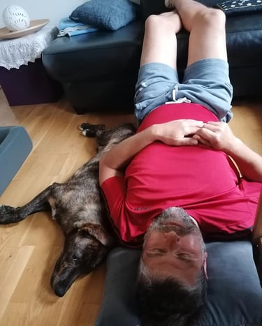 Martin und Milo liegen entspannt auf dem Boden. Milo übt die Lagerung ganz dicht bei Martin.