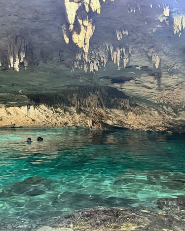 a person in a cave with a kayak