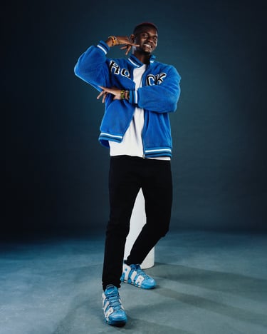 Afrofusion Beginner teacher Shawn of TheOne Studios in Nairobi, wearing blue college jacket 