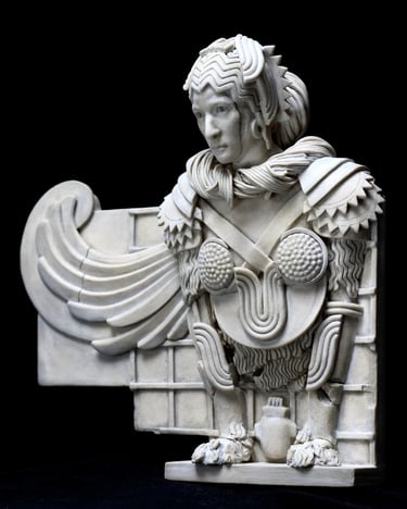 Small ceramic wall sculpture of a winged female Sphinx; left quarter view.