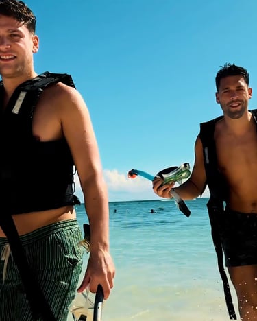 two men standing in the water with a parrot on their back