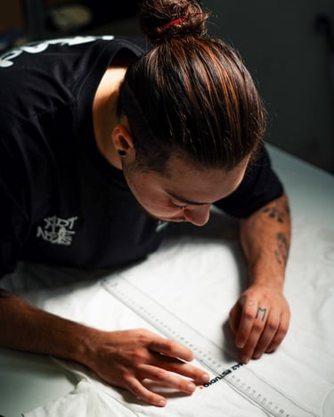 a man is looking down at a white sheet of paper