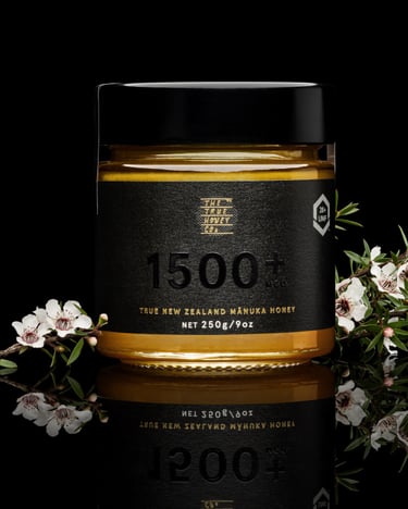 Product photography - a jar of honey with flowers and a black background