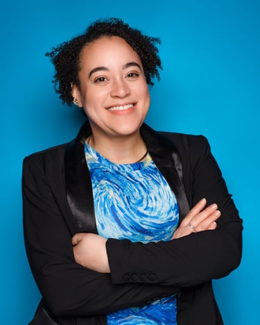 a woman in a blue dress shirt and black jacket