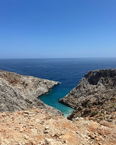 a person standing on a rocky cliff overlooking the ocean