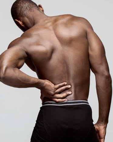 Male with hand on his back showcasing chronic pack pain