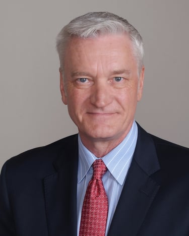 Photo of Dr. Garrick Villaume in suit and tie.
