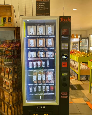 Commercial refrigerated vending machine stocked with snacks and beverages in Australia.