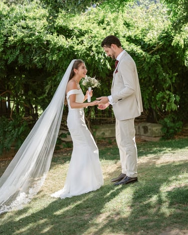 Wedding couple holding hands outdoors at a green Surrey wedding venue