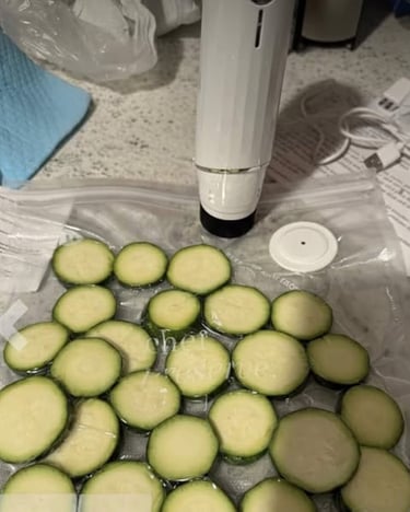 Vacuum sealer preserving sliced zucchini in a sealed bag on a kitchen countertop
