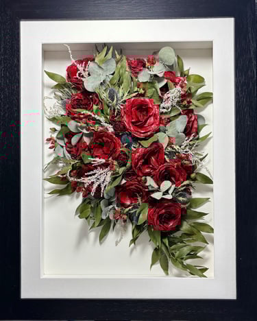 a Trailing view Style bouquet of flowers in a thin black frame