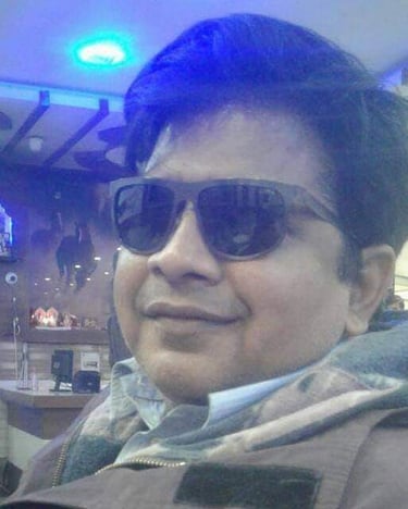 prashant srivastava in sunglasses and a scarf on a table