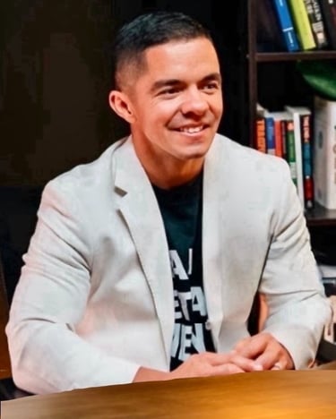 Cody Sechelski smiling in a white jacket, representing transformation from adversity to purpose-driven leadership