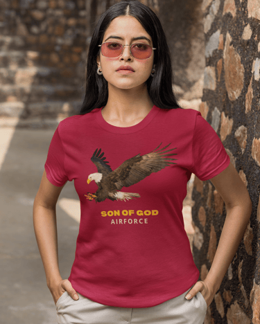 Woman in red t-shirt with eagle and "Son of God Airforce" design, representing faith and strength.