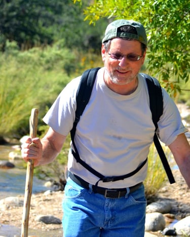 Crossing streams and bounding boulders during a trek to the summit