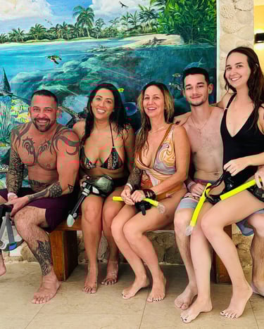 a group of people sitting on a bench in front of a mural of a painting