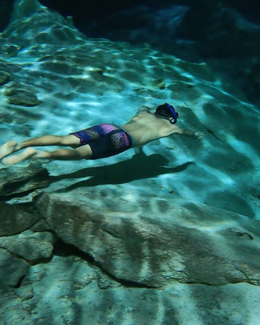 a man swimming in a pool with a snorh
