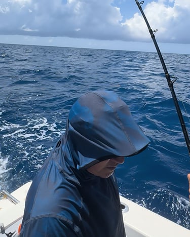 a man fishing in the ocean with a fishing rod