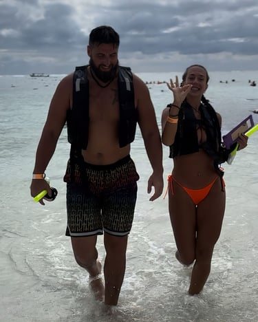 a man and woman walking in the water