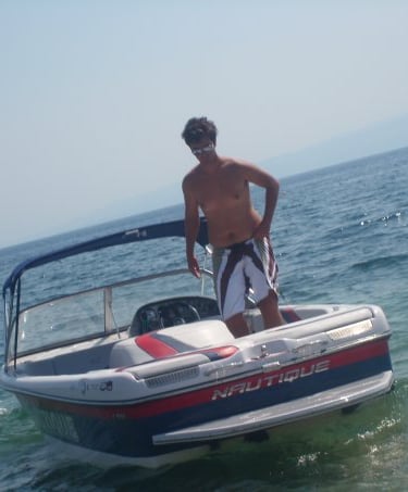 a man standing on a boat in the ocean