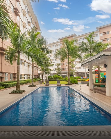 a pool with a gazeboar and palm trees