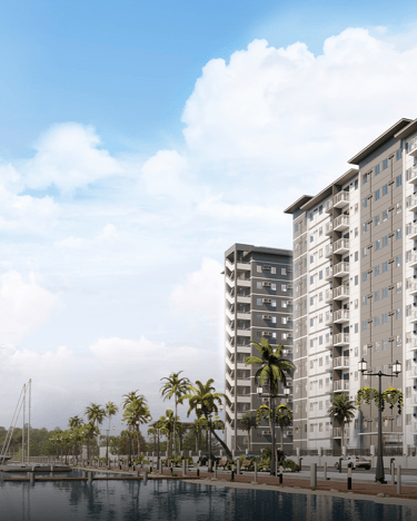a large apartment building with a boat in the water