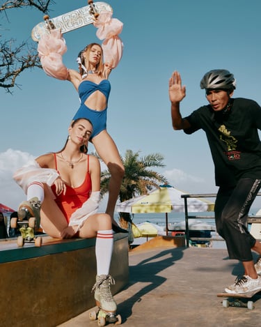 Two models in colorful swimwear posing with skateboard and roller skates at Bali skatepark for Kiniproduksi fashion editorial