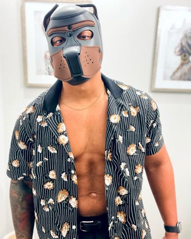 Man poses in a pup hood.
