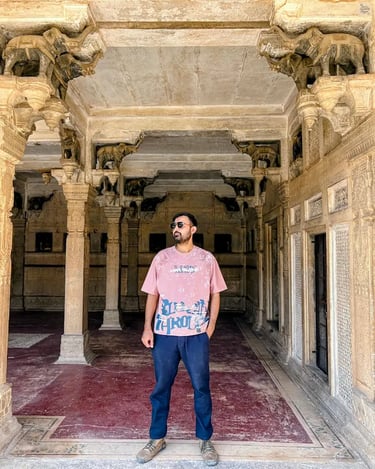 Traveler posing gracefully between the elephant columns of Baradari at Chhatar Mahal, Bundi, capturing the charm of royal-era