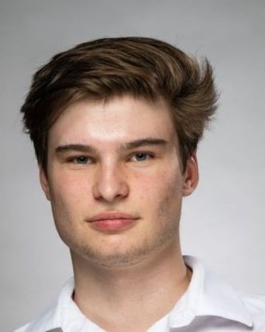 a man with a very short haircut and a white shirt